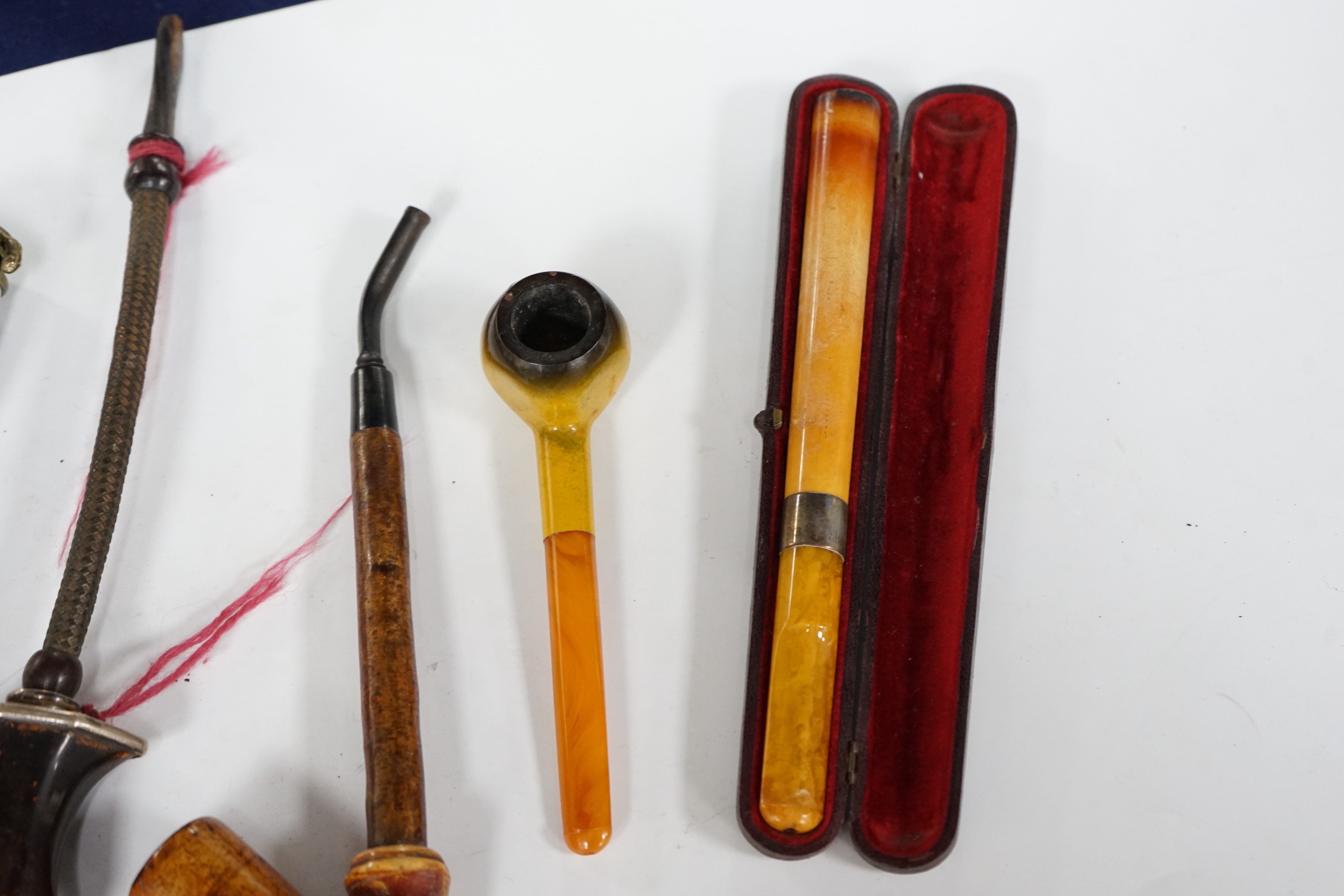 Seven pipes, three with amber mouthpieces, two cased and two without mouthpieces, longest cased pipe 20cm long
